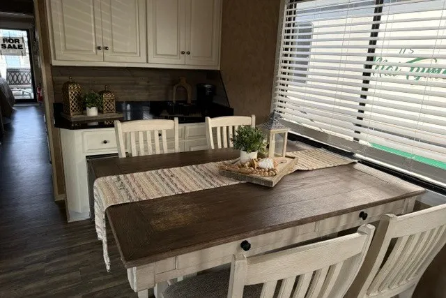 Slide: The Image of Dining area in a 1995 Stardust Cruisers 18 x 65 houseboat with wooden table and chairs. - 15
