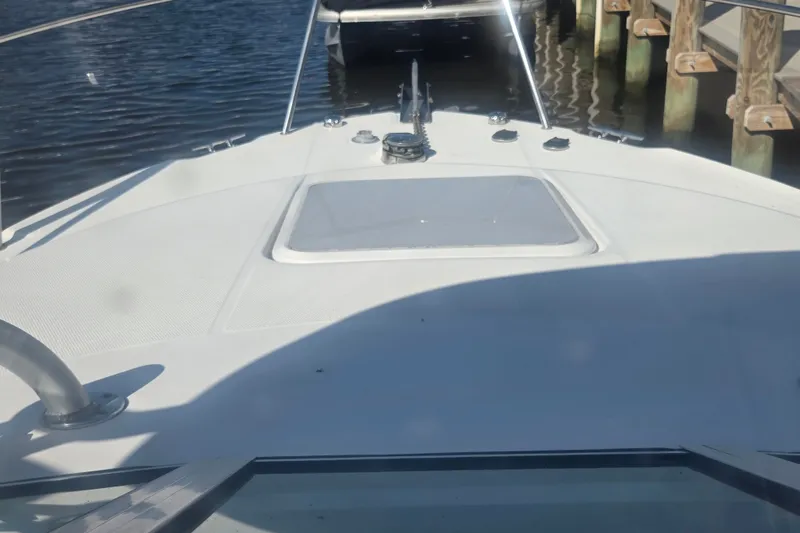 Slide: The Image of 2004 Wellcraft 252 Coastal boat docked, showing bow and deck details. - 17