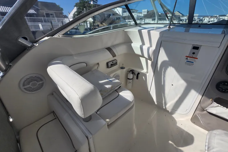 Slide: The Image of 2004 Wellcraft 252 Coastal boat interior with white seating and control panel. - 9