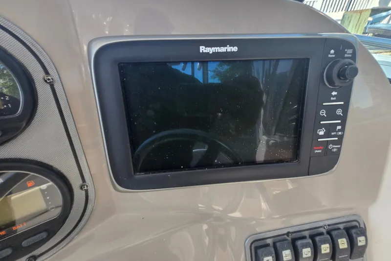 Slide: The Image of Raymarine display on 2004 Wellcraft 252 Coastal boat dashboard with control buttons. - 12