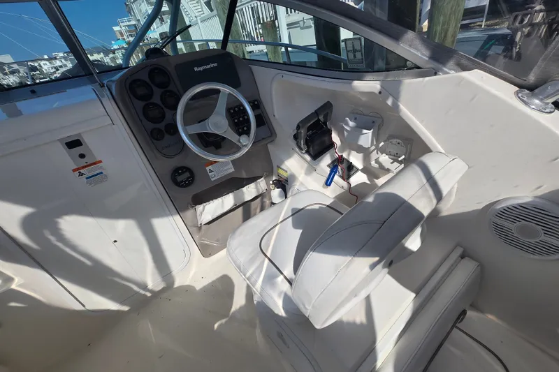 Slide: The Image of Interior view of 2004 Wellcraft 252 Coastal boat cockpit with steering wheel and controls. - 10