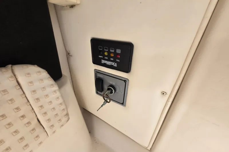 Slide: The Image of Control panel with key ignition on 2004 Wellcraft 252 Coastal boat interior. - 20