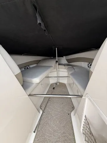 Slide: The Image of Interior view of a 2007 Larson LXi 268 with cushioned seating and carpeted floor. - 11