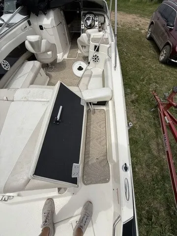 Slide: The Image of The image shows the cockpit of a 2007 Larson LXi 268 boat with white seating and a black table. - 27