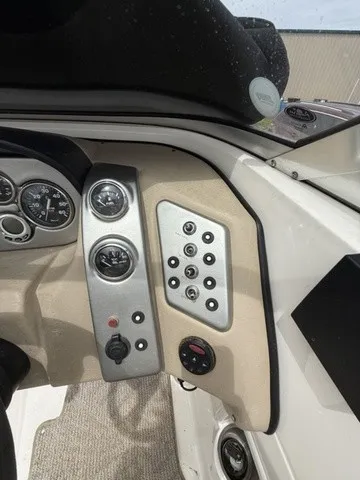 Slide: The Image of The image shows the dashboard of a 2007 Larson LXi 268 boat with various gauges and switches. - 15