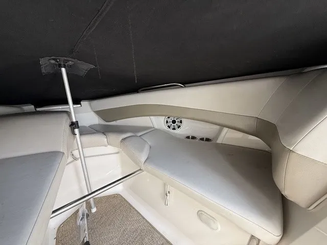 Slide: The Image of Interior view of a 2007 Larson LXi 268 with cushioned seating and speakers. - 9