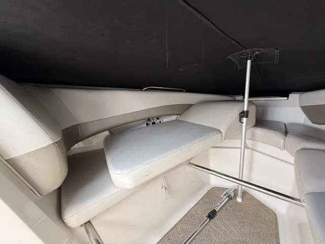Slide: The Image of Interior view of a 2007 Larson LXi 268 with cushioned seating and a speaker. - 10