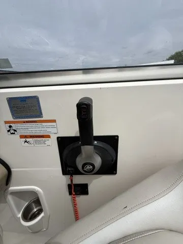Slide: The Image of Close-up of a boat throttle lever with safety warnings and a cup holder. - 14