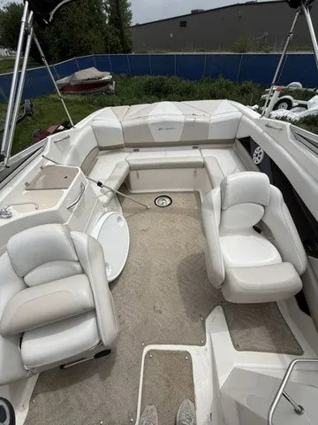 Slide: The Image of The image shows the cockpit of a 2007 Larson LXi 268 with white upholstery and carpet flooring. - 6