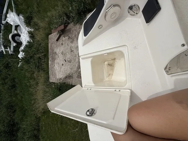 Slide: The Image of An open storage compartment on a boat with a person sitting beside it. - 28