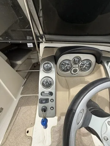 Slide: The Image of The image shows the dashboard of a 2007 Larson LXi 268 with multiple gauges and a steering wheel. - 13