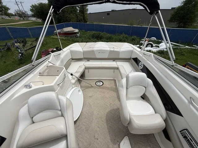 Slide: The Image of The image shows the cockpit of a 2007 Larson LXi 268 with white upholstered seats and carpeted floor. - 7