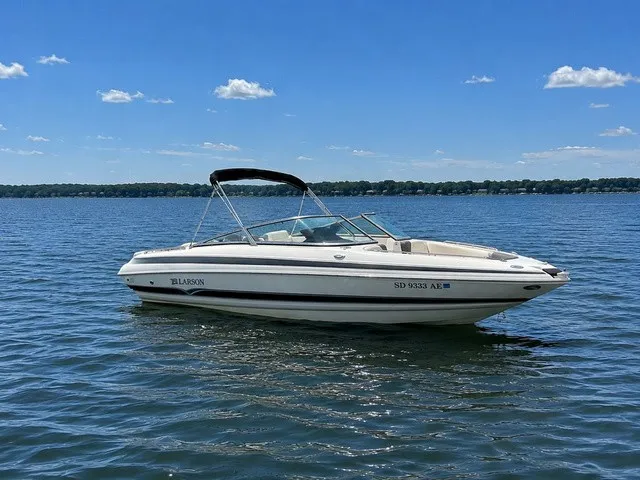 The Image of 2007 Larson LXi 268 on calm water with a clear sky. - 1