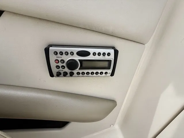 Slide: The Image of A built-in control panel on a boat, surrounded by beige upholstery. - 19