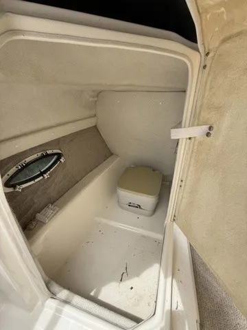 Slide: The Image of Interior of a 2007 Larson LXi 268 featuring a small toilet and a porthole. - 18