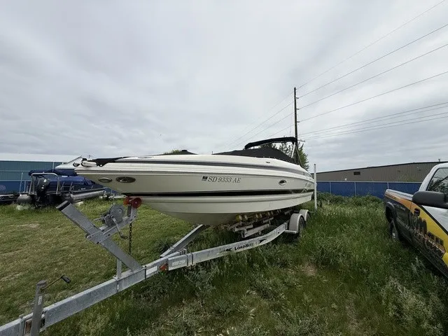 Slide: The Image of A white boat on a trailer in a grassy area, with a cloudy sky in the background. - 33