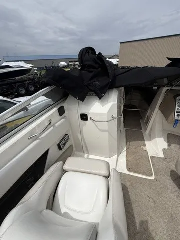 Slide: The Image of The image shows the cockpit of a 2007 Larson LXi 268 with white seats and carpeted flooring. - 20