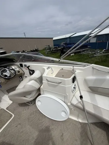 Slide: The Image of The image shows the cockpit of a 2007 Larson LXi 268 boat with a helm and seating area. - 25