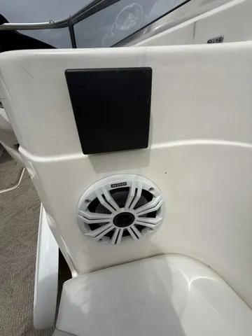 Slide: The Image of A speaker is mounted in the white interior paneling of a boat. - 26