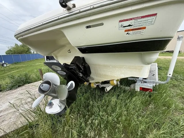 Slide: The Image of The image shows the stern of a white boat with a propeller and trailer in the grass. - 5
