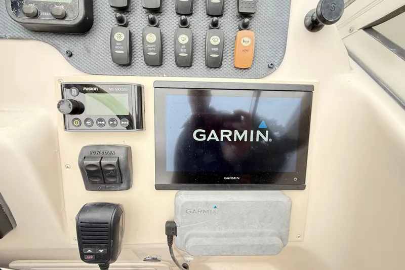 Slide: The Image of Control panel of a 2007 Grady-White Tournament 205 with Garmin and Fusion systems. - 23