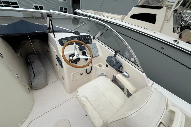 Slide: The Image of 2007 Grady-White Tournament 205 boat cockpit with steering wheel and controls. - 11