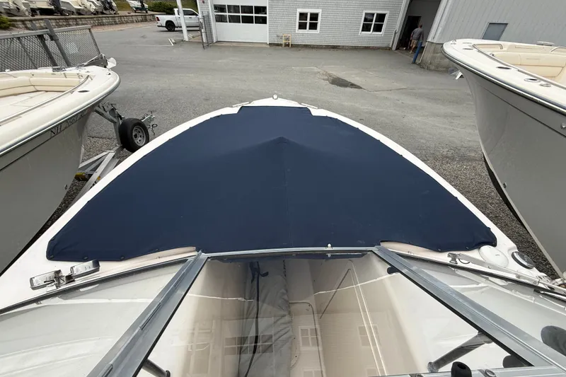 Slide: The Image of 2007 Grady-White Tournament 205 boat with blue bow cover in a marina setting. - 14