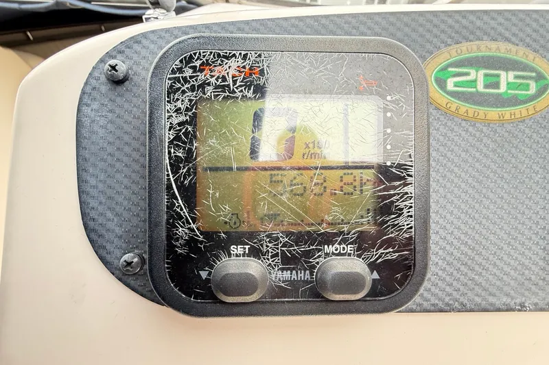 Slide: The Image of Close-up of a scratched Yamaha boat display on a 2007 Grady-White Tournament 205. - 22