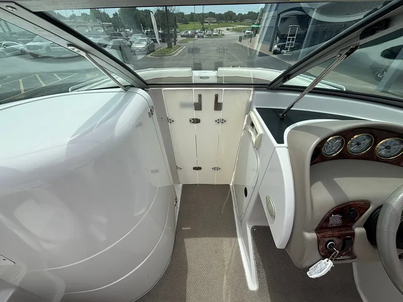 Slide: The Image of The image shows the cockpit of a 2003 Four Winns 214 Fun Ship with helm and instruments. - 30