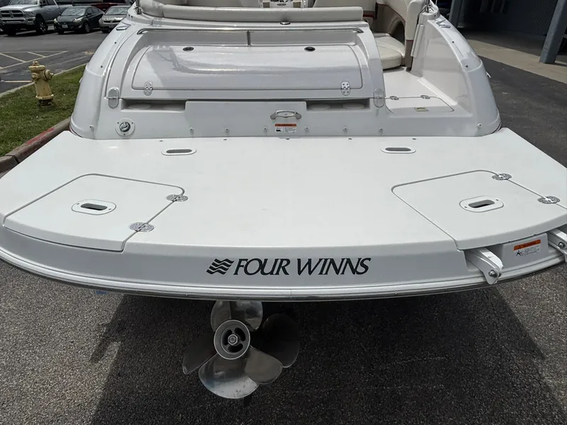 Slide: The Image of The image shows the stern of a 2003 Four Winns 214 Fun Ship with a propeller. - 10