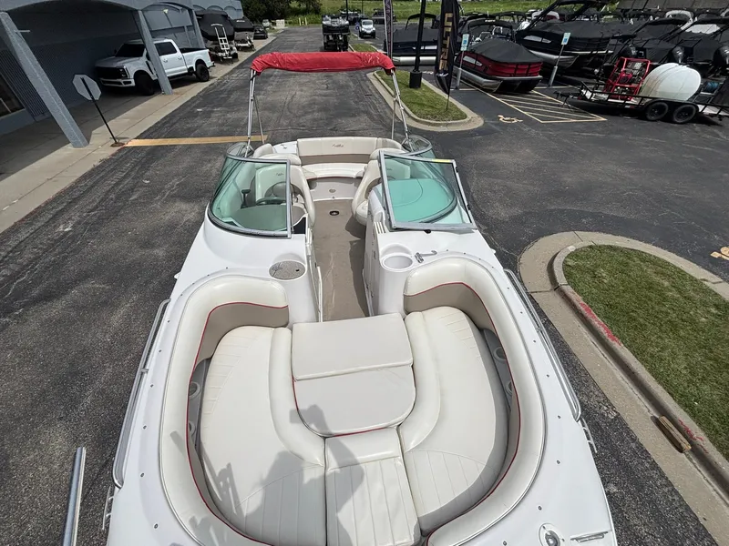 Slide: The Image of A 2003 Four Winns 214 Fun Ship with white and red interior, parked in a lot. - 13