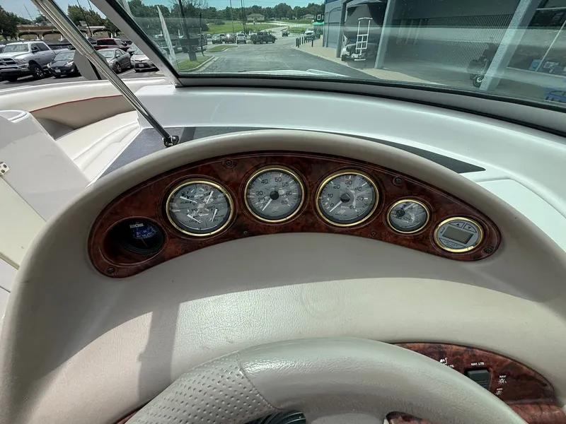 Slide: The Image of Dashboard of a 2003 Four Winns 214 Fun Ship with multiple gauges and a steering wheel. - 25