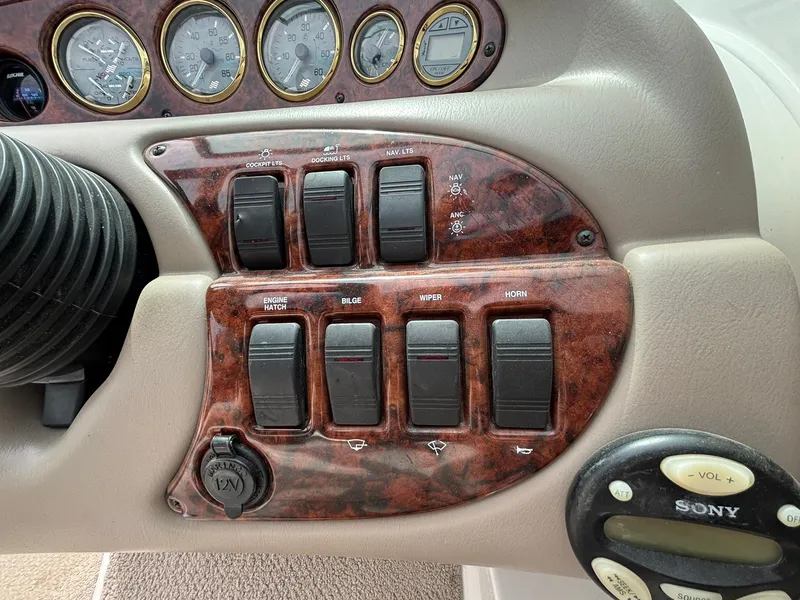 Slide: The Image of Close-up of a 2003 Four Winns 214 Fun Ship dashboard with switches and gauges. - 27