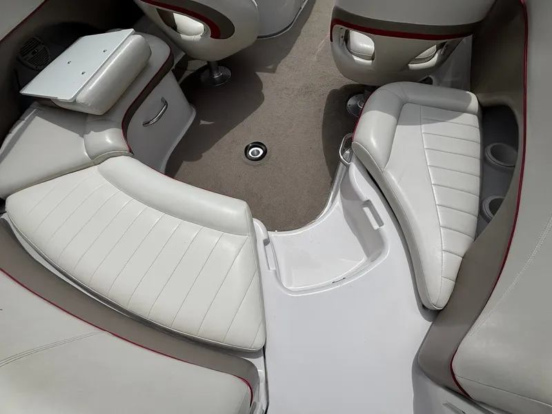 Slide: The Image of The image shows the cockpit of a 2003 Four Winns 214 Fun Ship with white upholstered seats. - 18