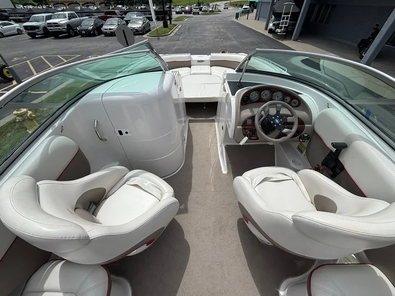 Slide: The Image of The image shows the cockpit of a 2003 Four Winns 214 Fun Ship with white leather seats. - 22