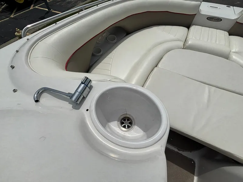 Slide: The Image of The image shows the cockpit of a 2003 Four Winns 214 Fun Ship with a built-in sink. - 31