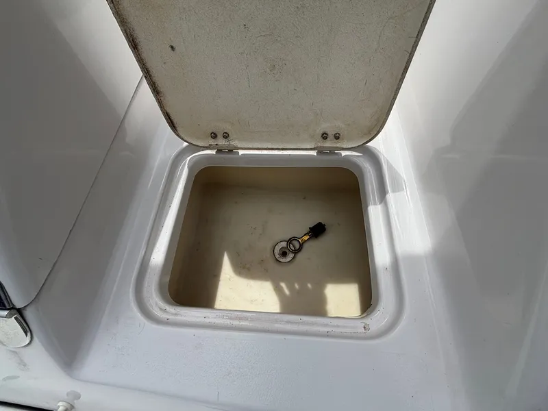 Slide: The Image of An open storage compartment on a boat with a set of keys inside. - 16