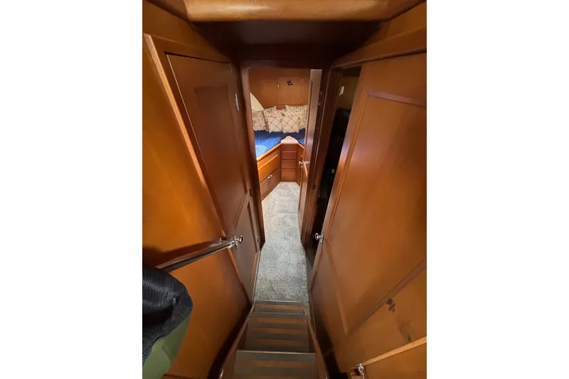Slide: The Image of Interior view of 1969 Hatteras 38 Double Cabin with wooden paneling and cozy bedroom. - 18