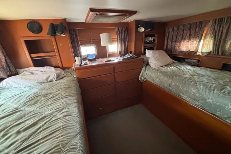Slide: The Image of 1969 Hatteras 38 Double Cabin interior with twin beds and wooden cabinetry. - 29