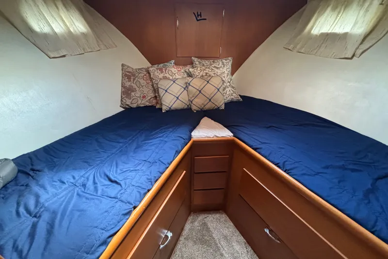 Slide: The Image of Cozy cabin interior of 1969 Hatteras 38 Double Cabin with blue bedding and pillows. - 20