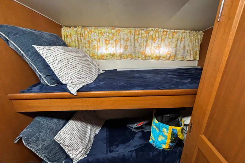 Slide: The Image of Cozy cabin interior of 1969 Hatteras 38 Double Cabin with bunk beds and floral curtains. - 21