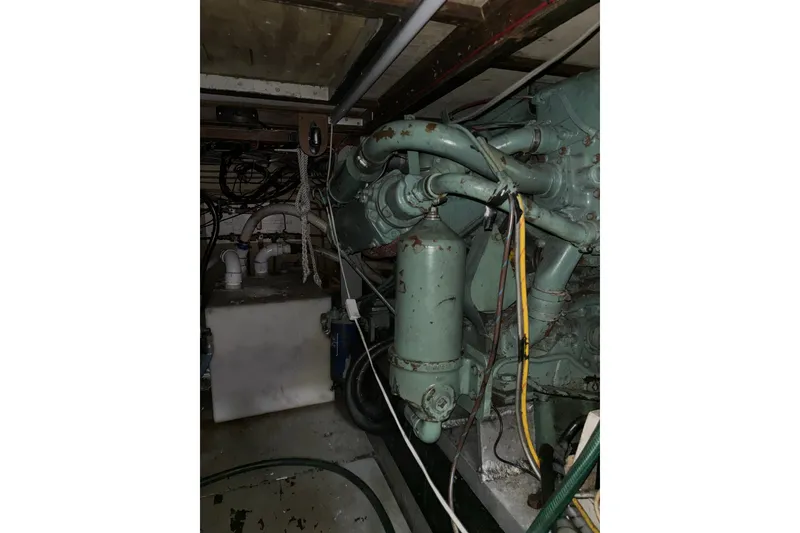 Slide: The Image of Engine room of a 1969 Hatteras 38 Double Cabin boat, showing machinery and wiring. - 34