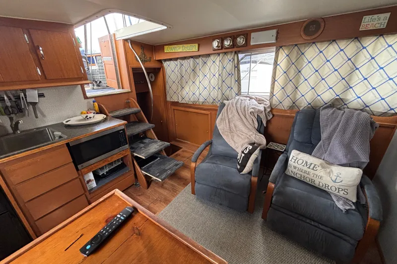 Slide: The Image of Interior of 1969 Hatteras 38 Double Cabin with cozy seating and kitchen area. - 17