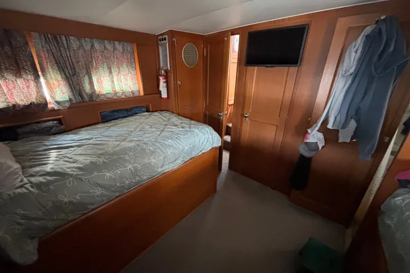 Slide: The Image of Cozy cabin interior of 1969 Hatteras 38 Double Cabin with bed and wooden furnishings. - 30