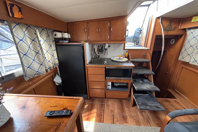 Slide: The Image of Interior of 1969 Hatteras 38 Double Cabin with kitchen and wooden cabinetry. - 16