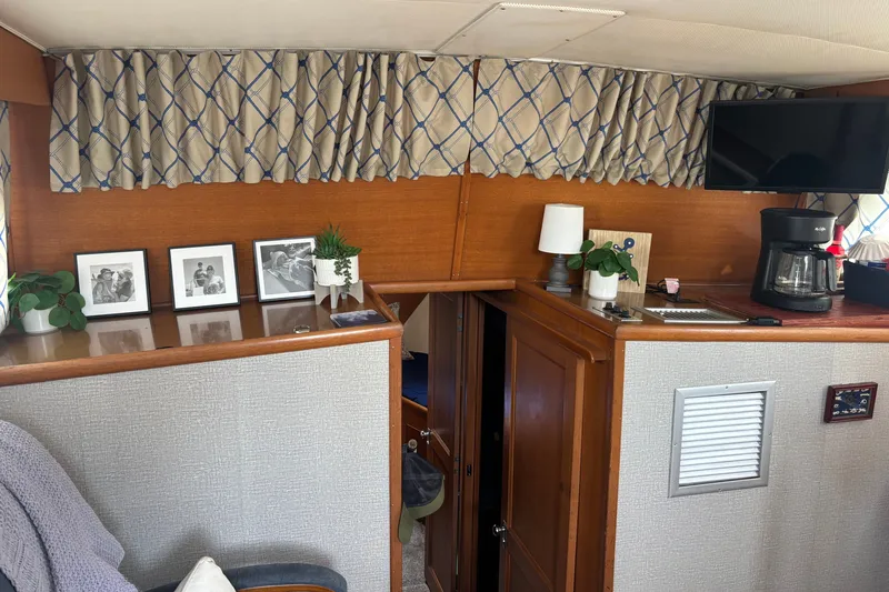 Slide: The Image of Interior of 1969 Hatteras 38 Double Cabin with decor, photos, and coffee maker. - 14