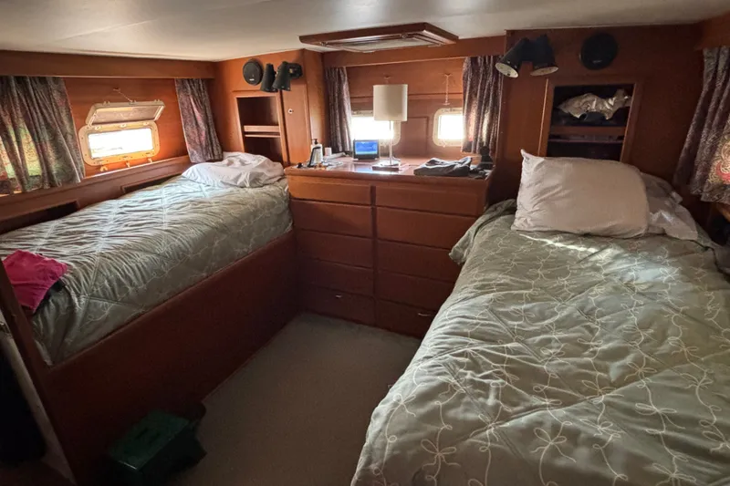 Slide: The Image of Interior of 1969 Hatteras 38 Double Cabin with twin beds and wooden furnishings. - 26