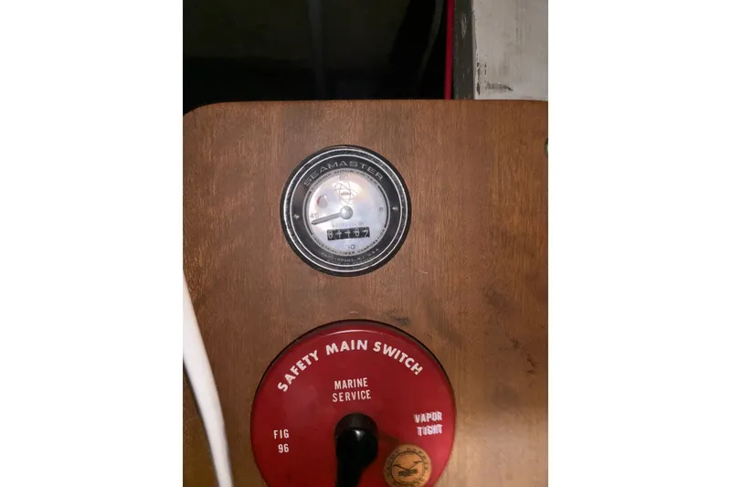 Slide: The Image of 1969 Hatteras 38 Double Cabin marine gauge and safety main switch panel. - 23