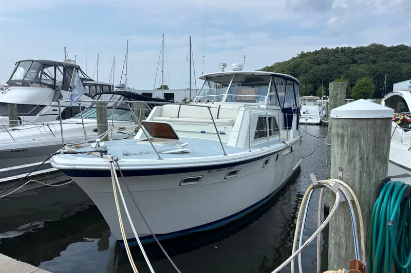 The Image of 1969 Hatteras 38 Double Cabin yacht docked at marina with other boats. - 0