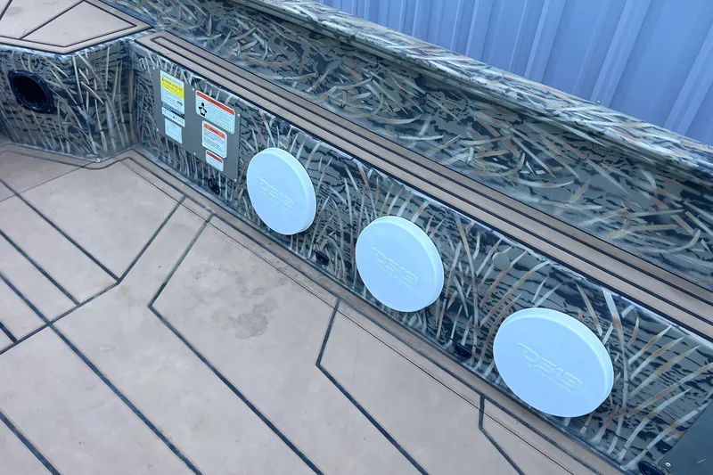 Slide: The Image of 2025 Tracker Grizzly 1650 T Prairie Wings Edition boat interior with camo design and speakers. - 14